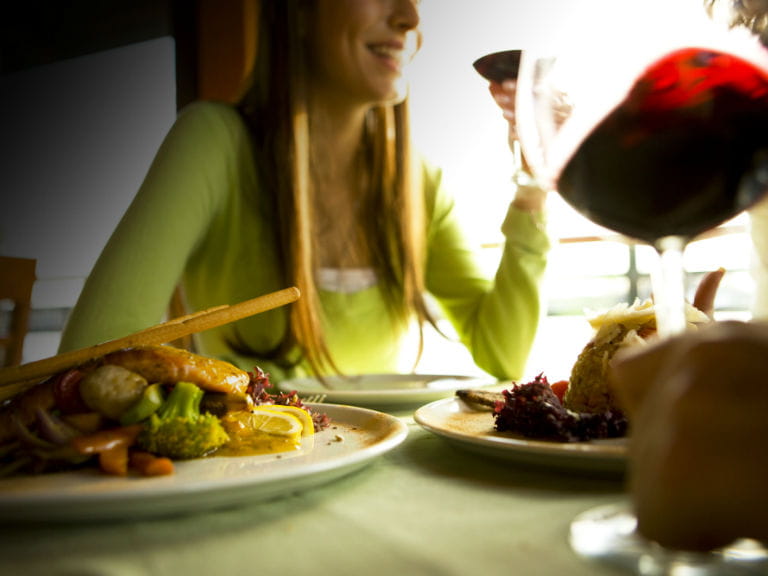 Woman drinking red wine in a restaurant
