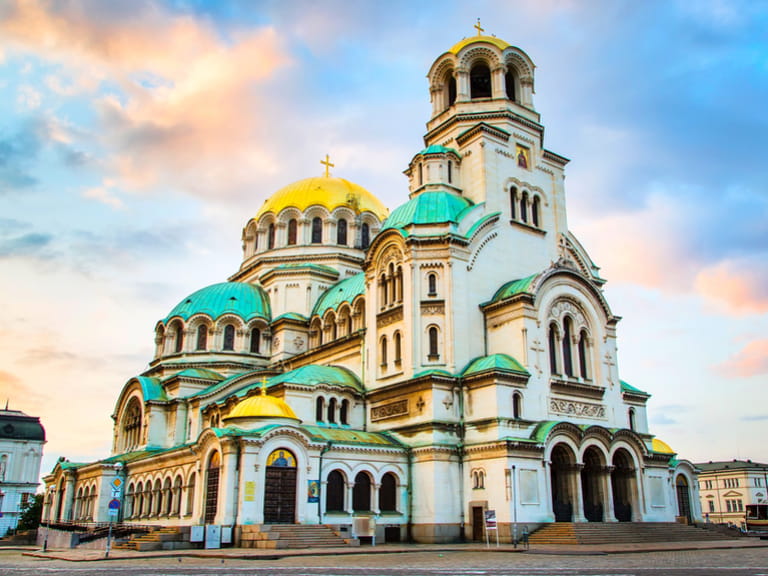 St. Alexander Nevsky Cathedral in the center of Sofia, capital of Bulgaria against the blue morning sky with colorful clouds