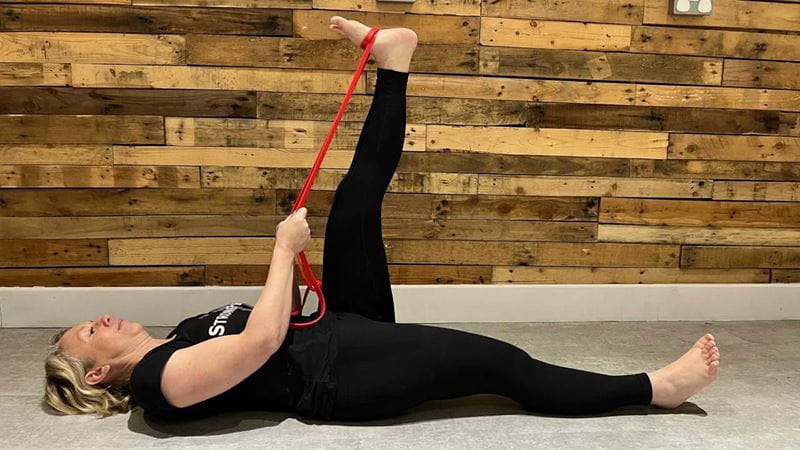 Lying hamstring stretch with band helps with tight muscle stiffness