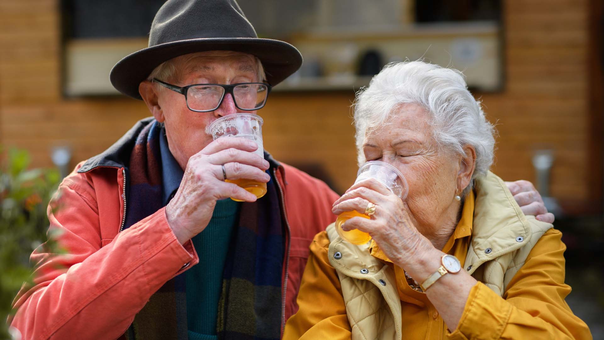 An older couple drinking beer together