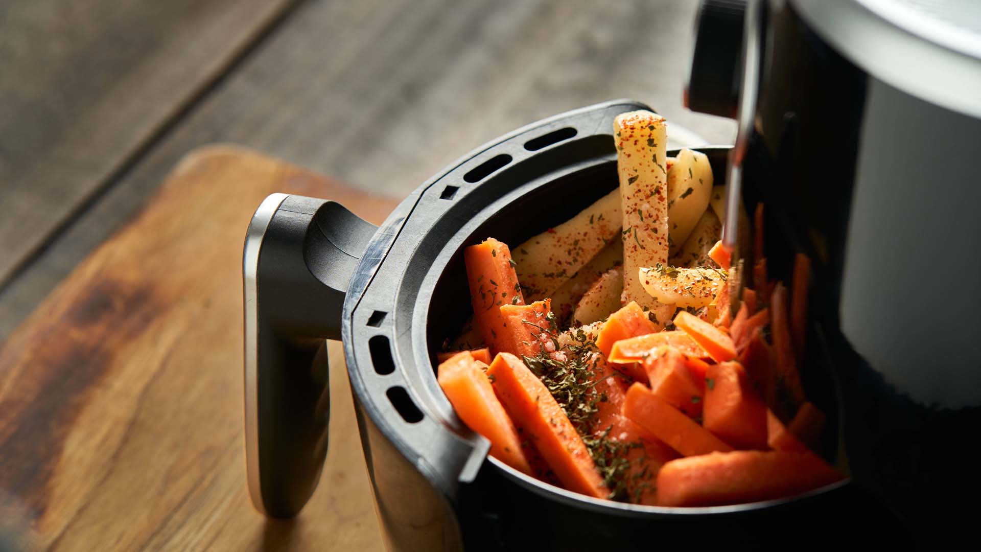 Close-up of an air fryer drawer containing chips.