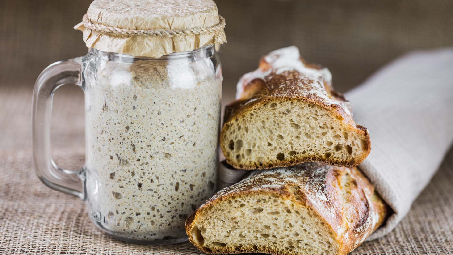 Sourdough bread and a starter inca jar