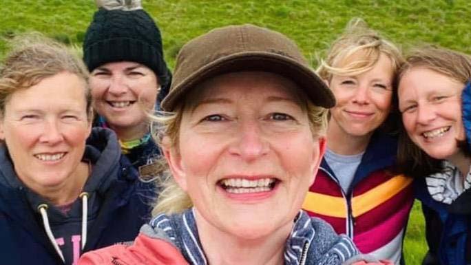 A group of women hikers smiling for the camera