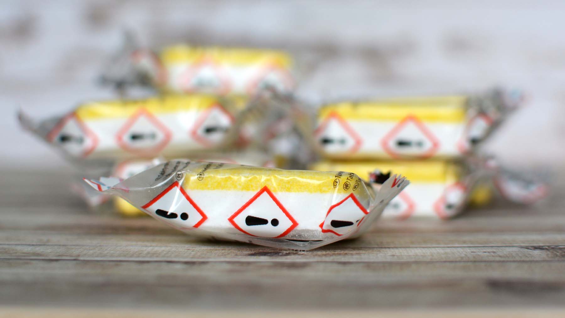 Close-up of single-use, plastic-wrapped dishwasher tablets