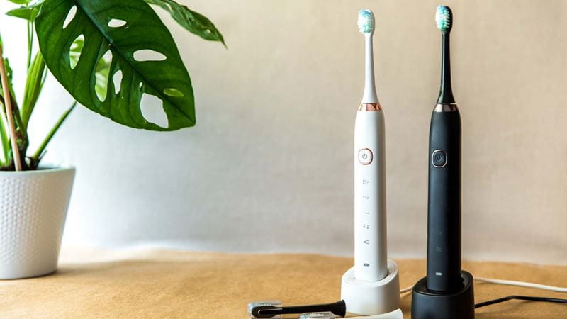 One black and one white electric toothbrush