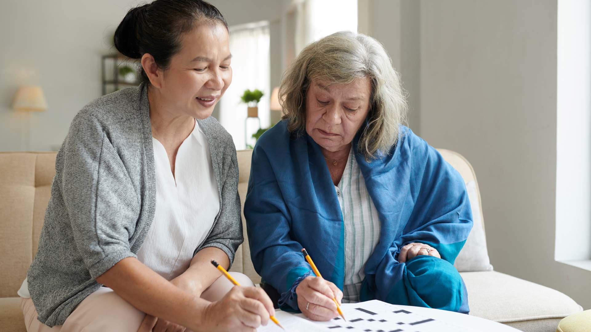 Two women doing crossword puzzle