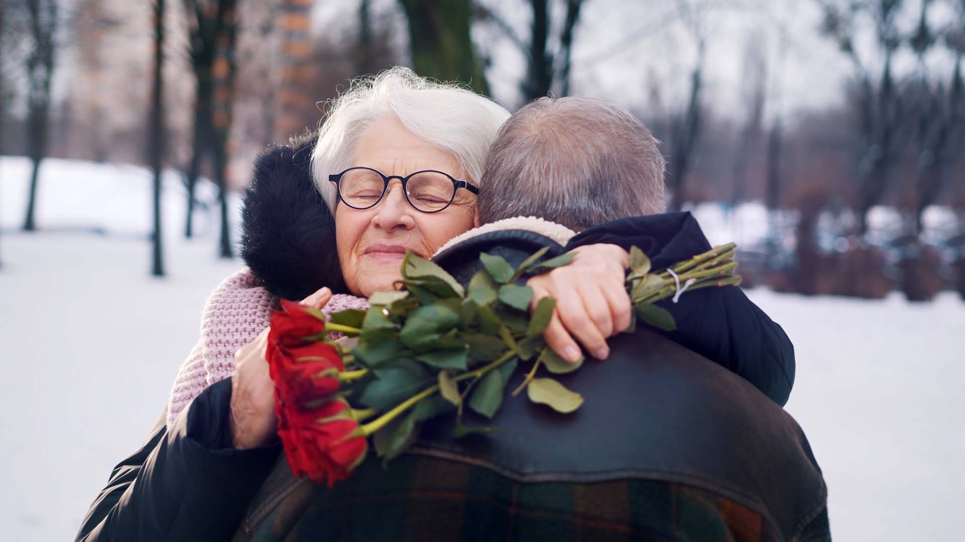 Woman and man hugging with roses