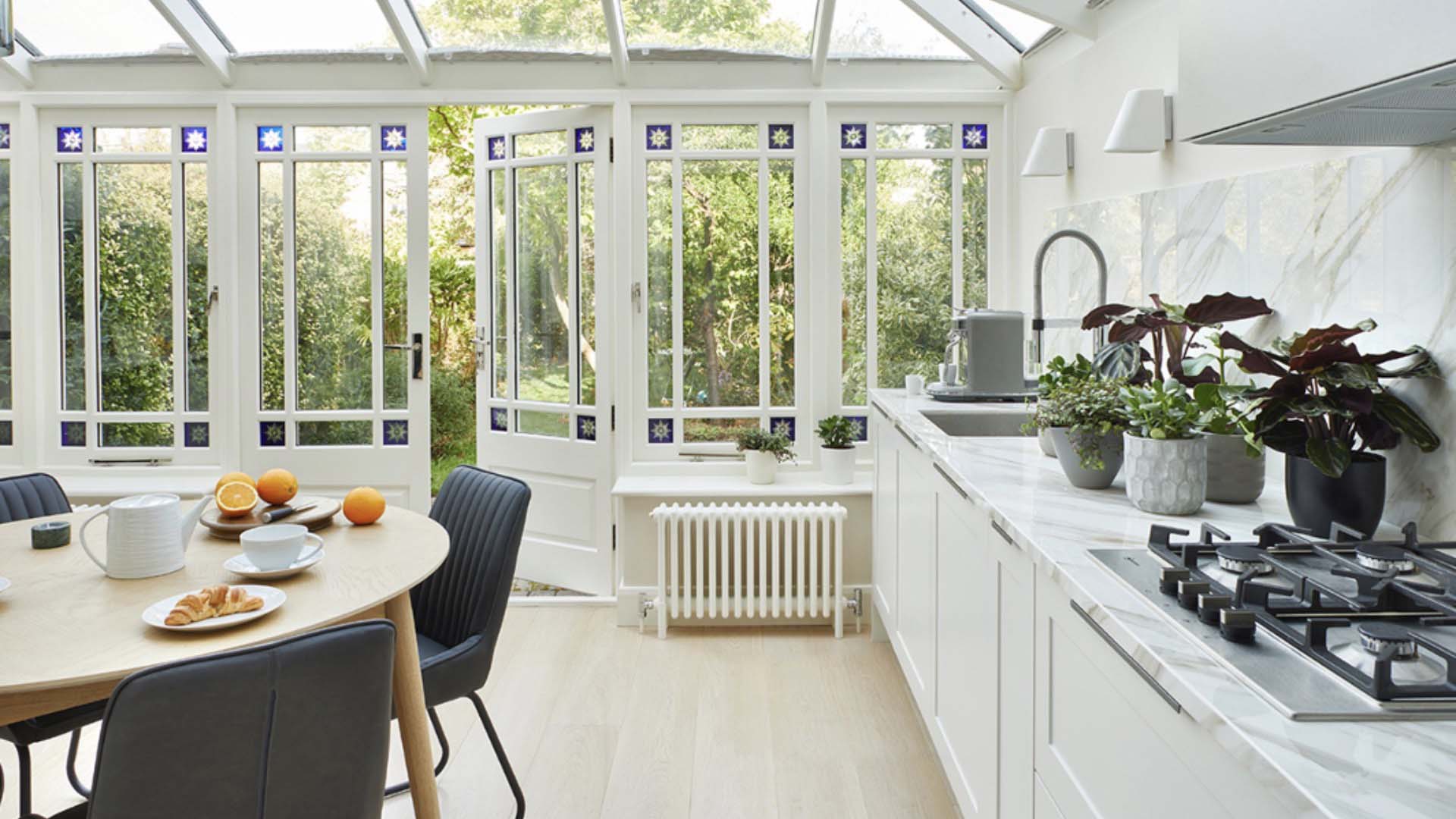A kitchen conservatory with glass doors and windows can fill a room with light