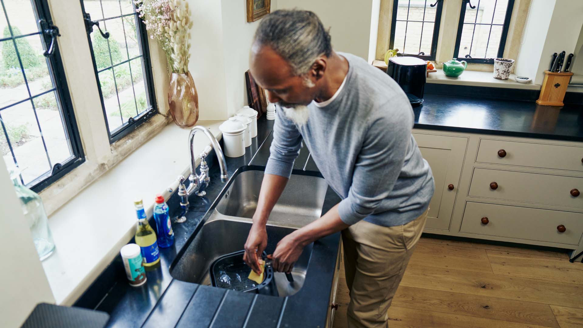 A man cleaning out an air fryer