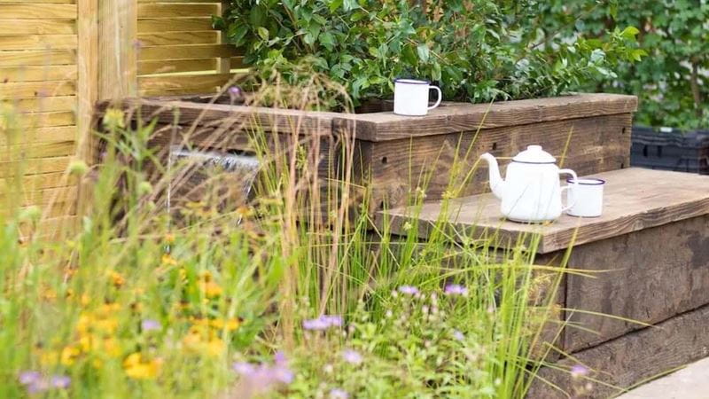 rustic wooden planters surrounded by grasses