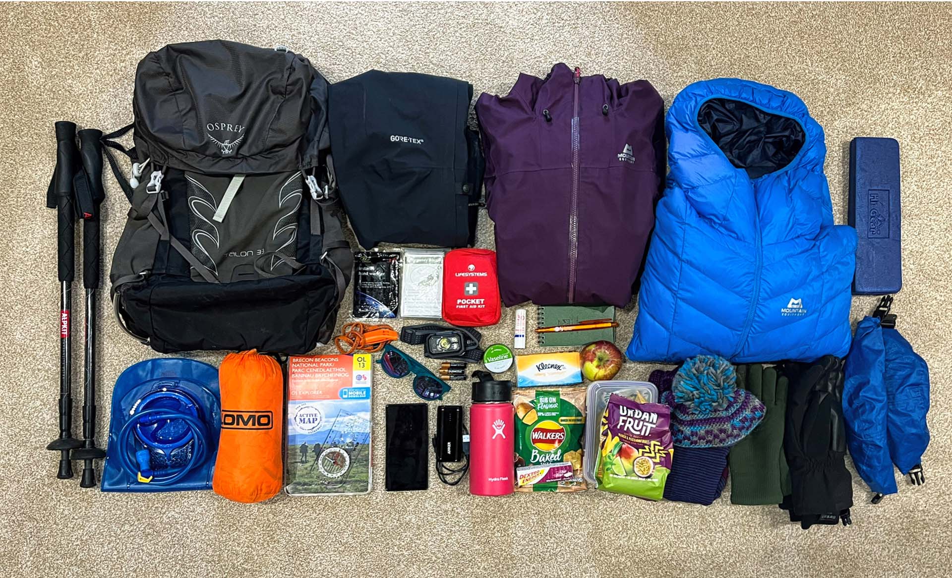 The contents of a rucksack laid out beside it 