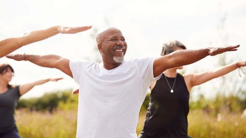 People doing yoga balances outdoors