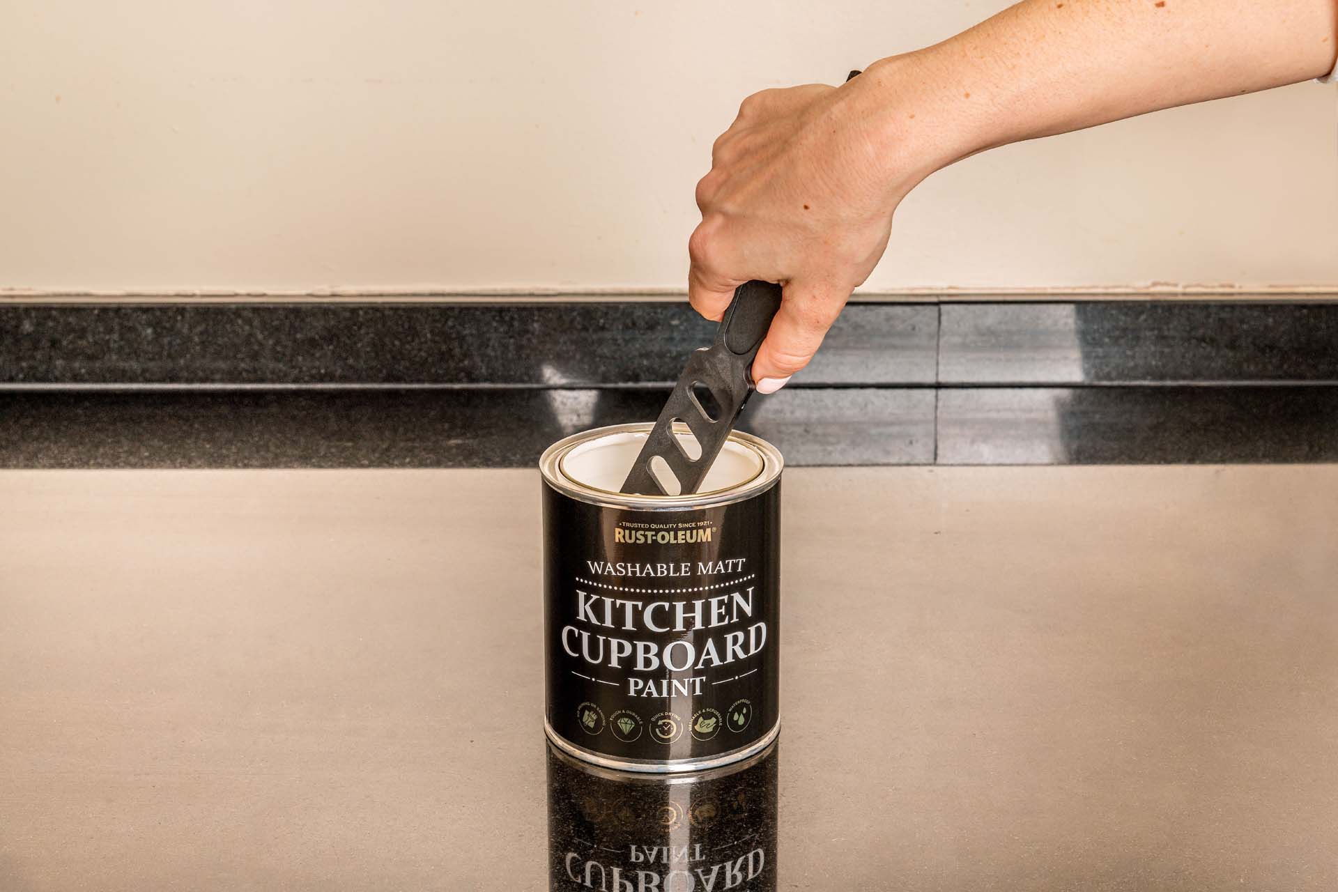 Paint being stirred in the tin