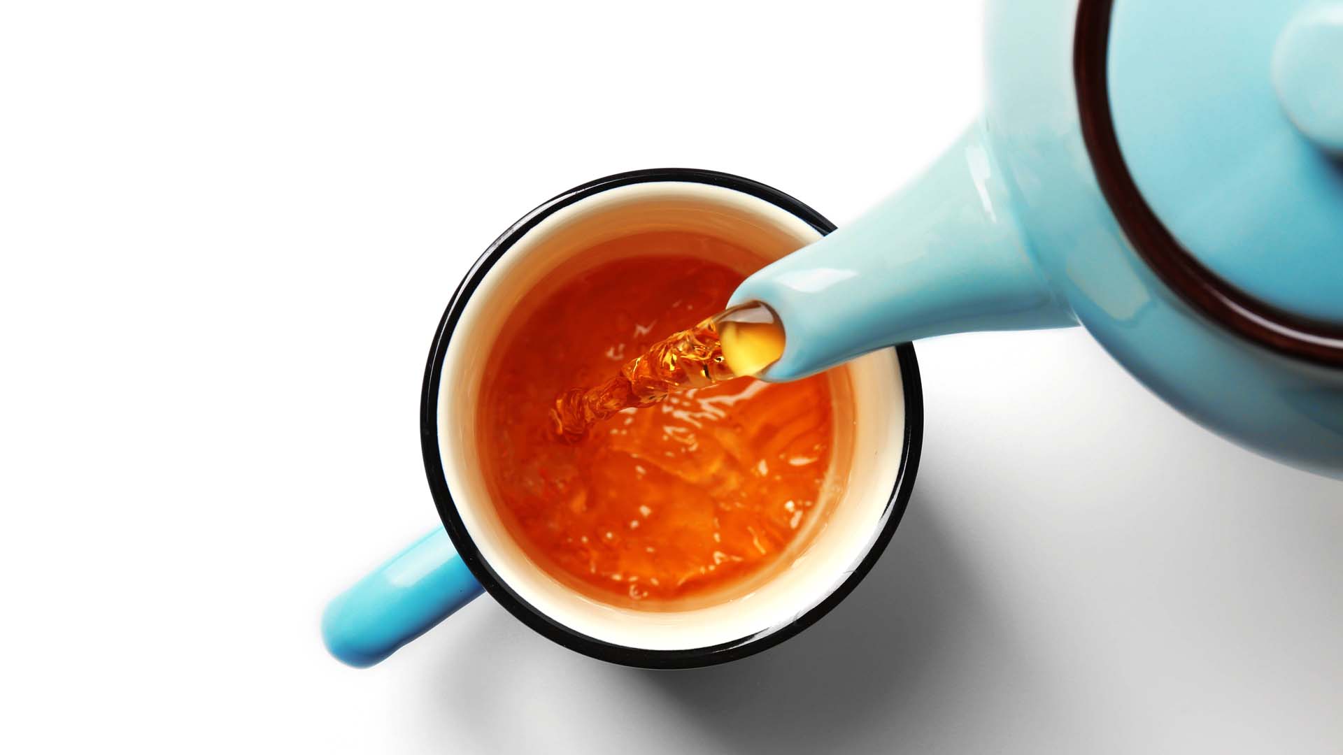 Tea poured into a cup from a teapot