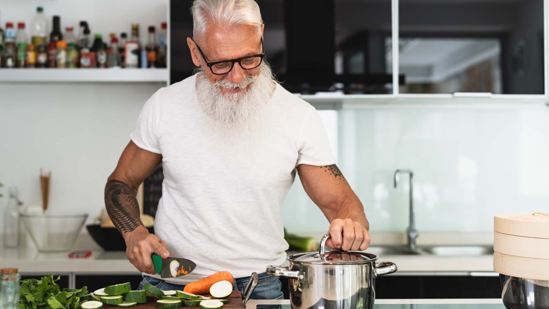 man with beard and tattoos doing the cooking