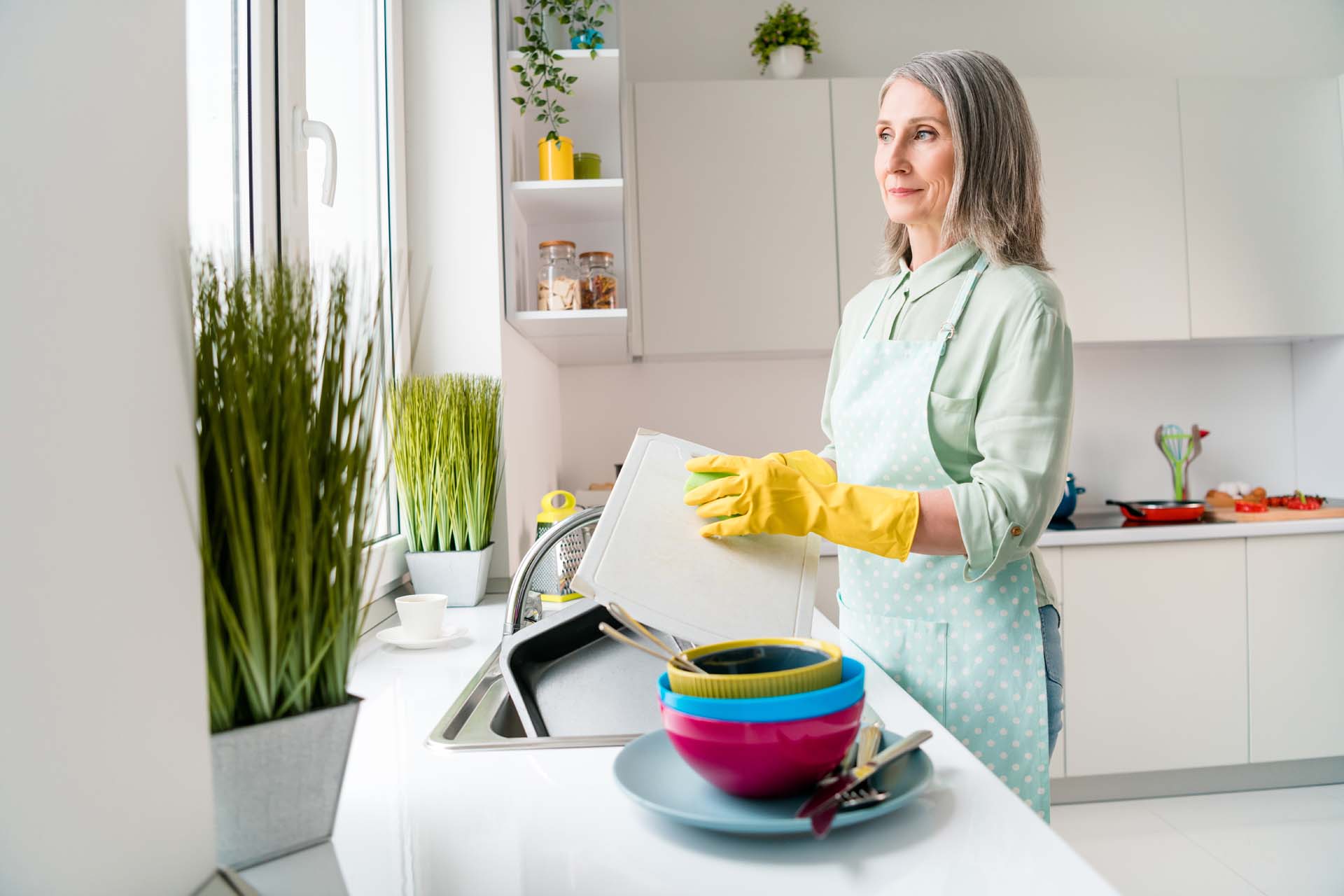 Woman washing dishes in a kitchen