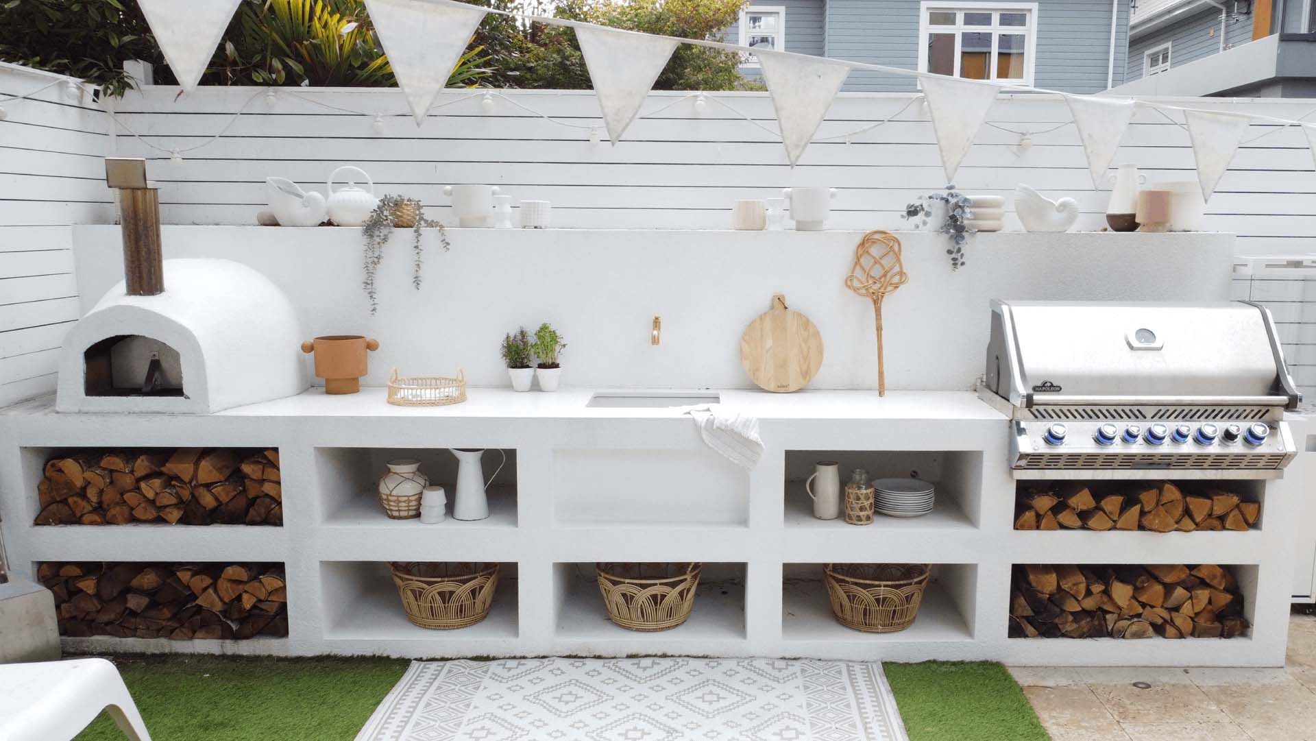 whitewashed cladding concrete with an open-front, rustic style that lets the logs become part of the design