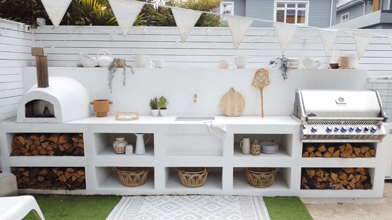 whitewashed cladding concrete with an open-front, rustic style that lets the logs become part of the design