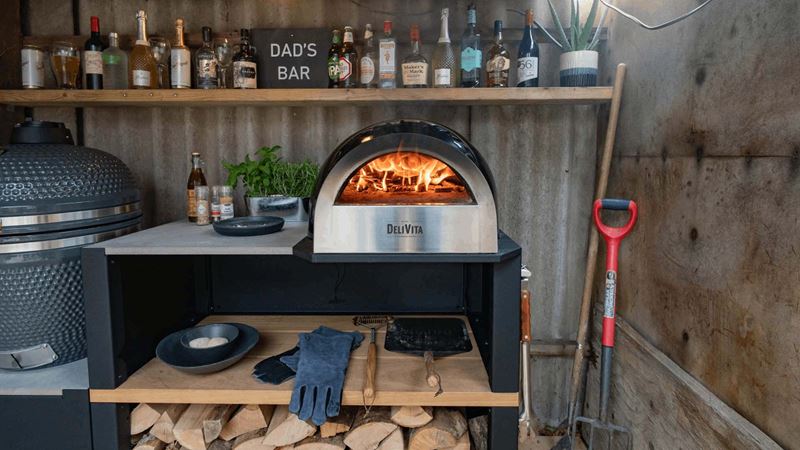 corrugated iron shed with a compact pizza oven, bar and egg-style barbecue