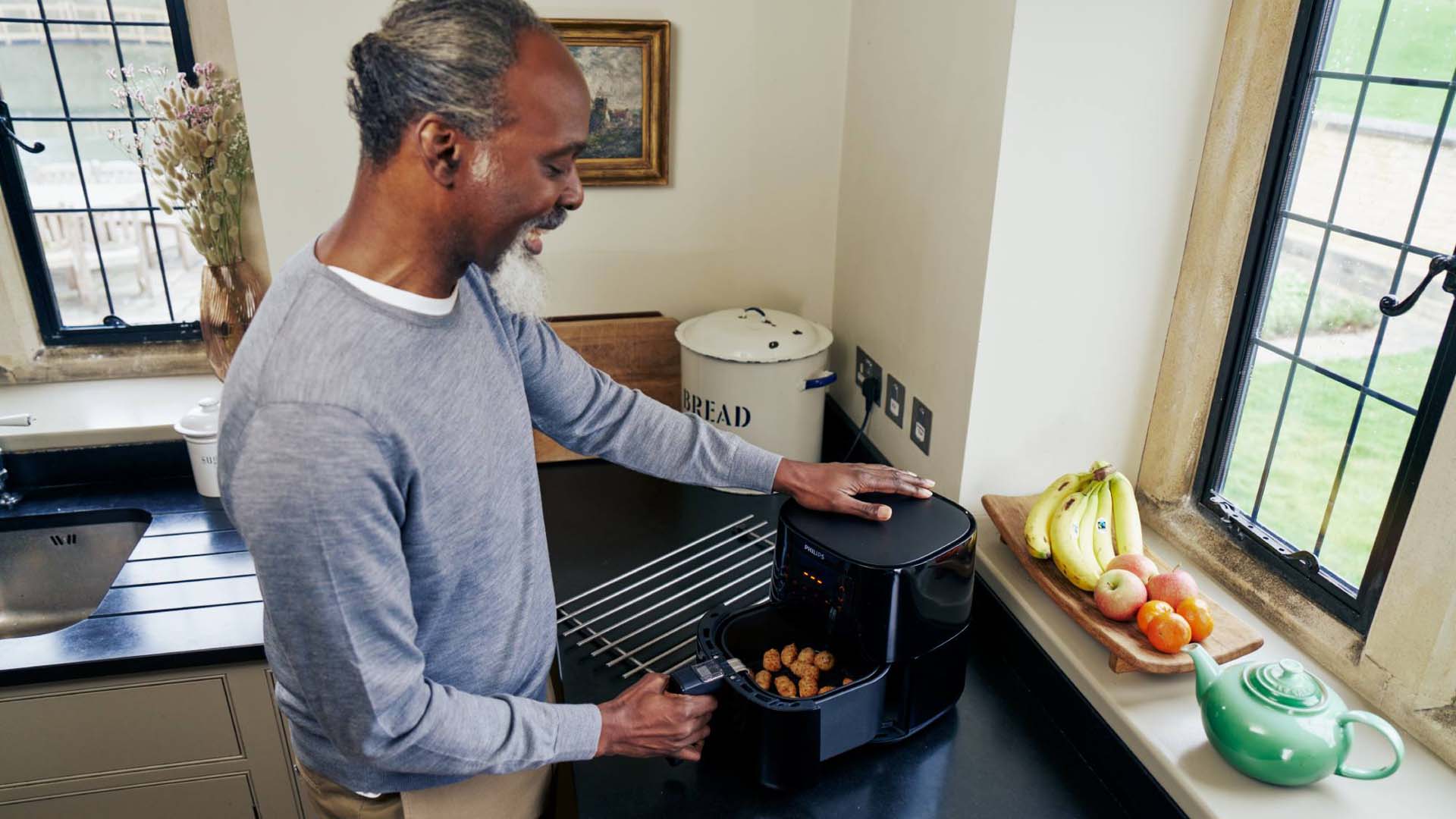 Man cooking food in an air fryer