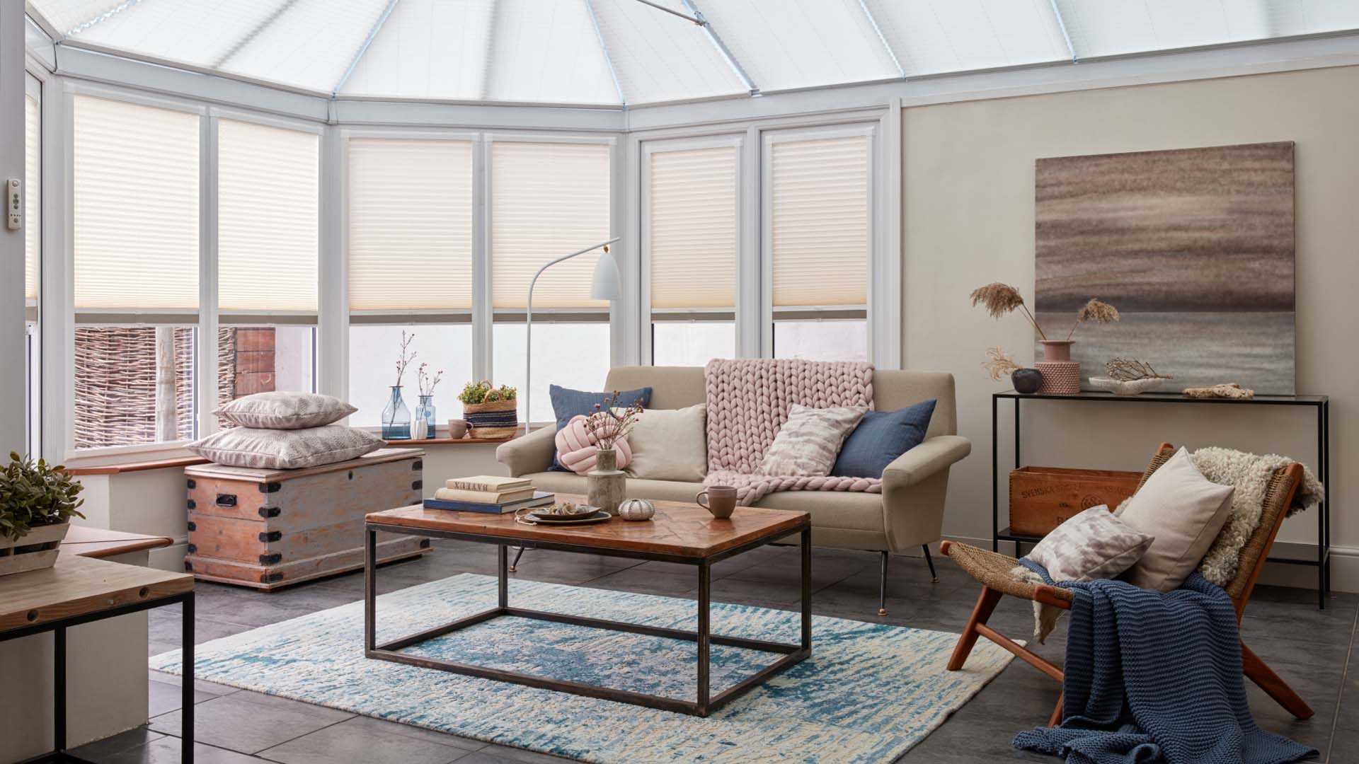 Interior view of a conservatory with part-closed beige blinds