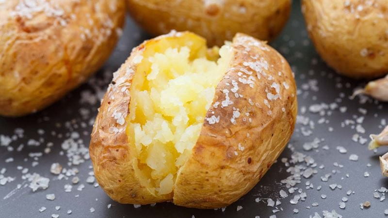 A fluffy baked potato with salt