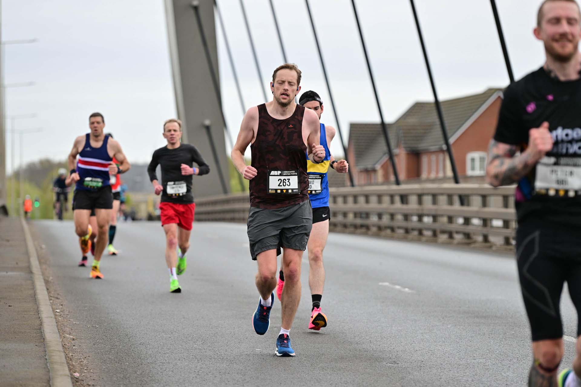 People running across a bridge for Newport marathon