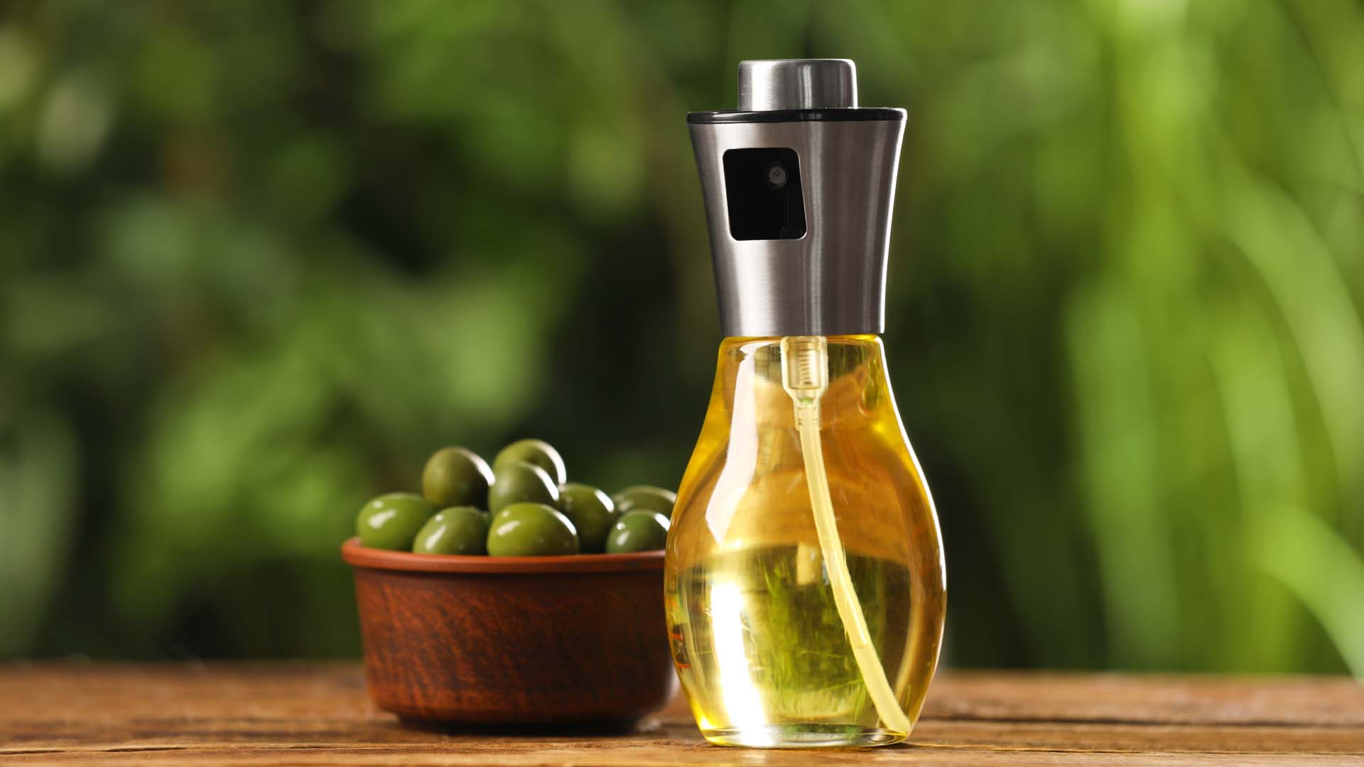 Oil bottle next to some olive oil