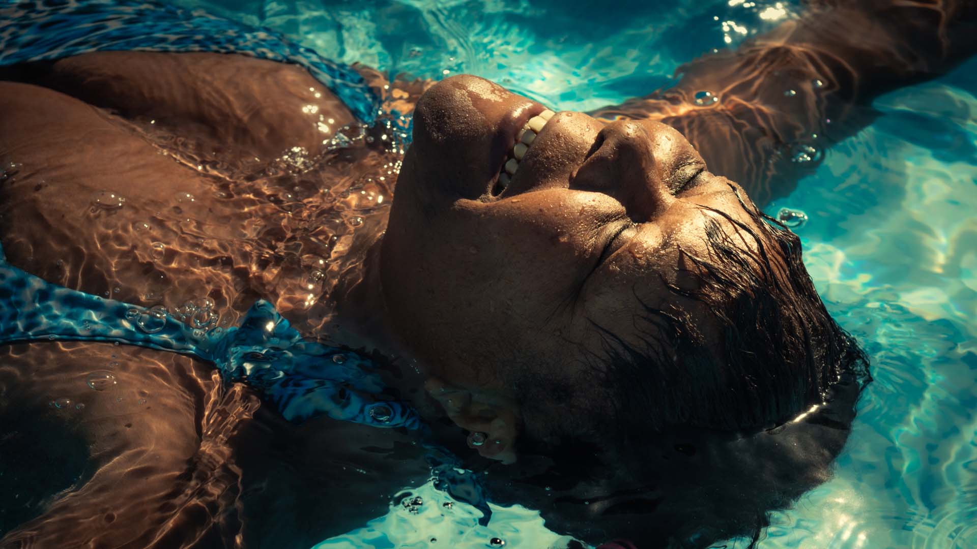 Lady enjoying lying in the pool