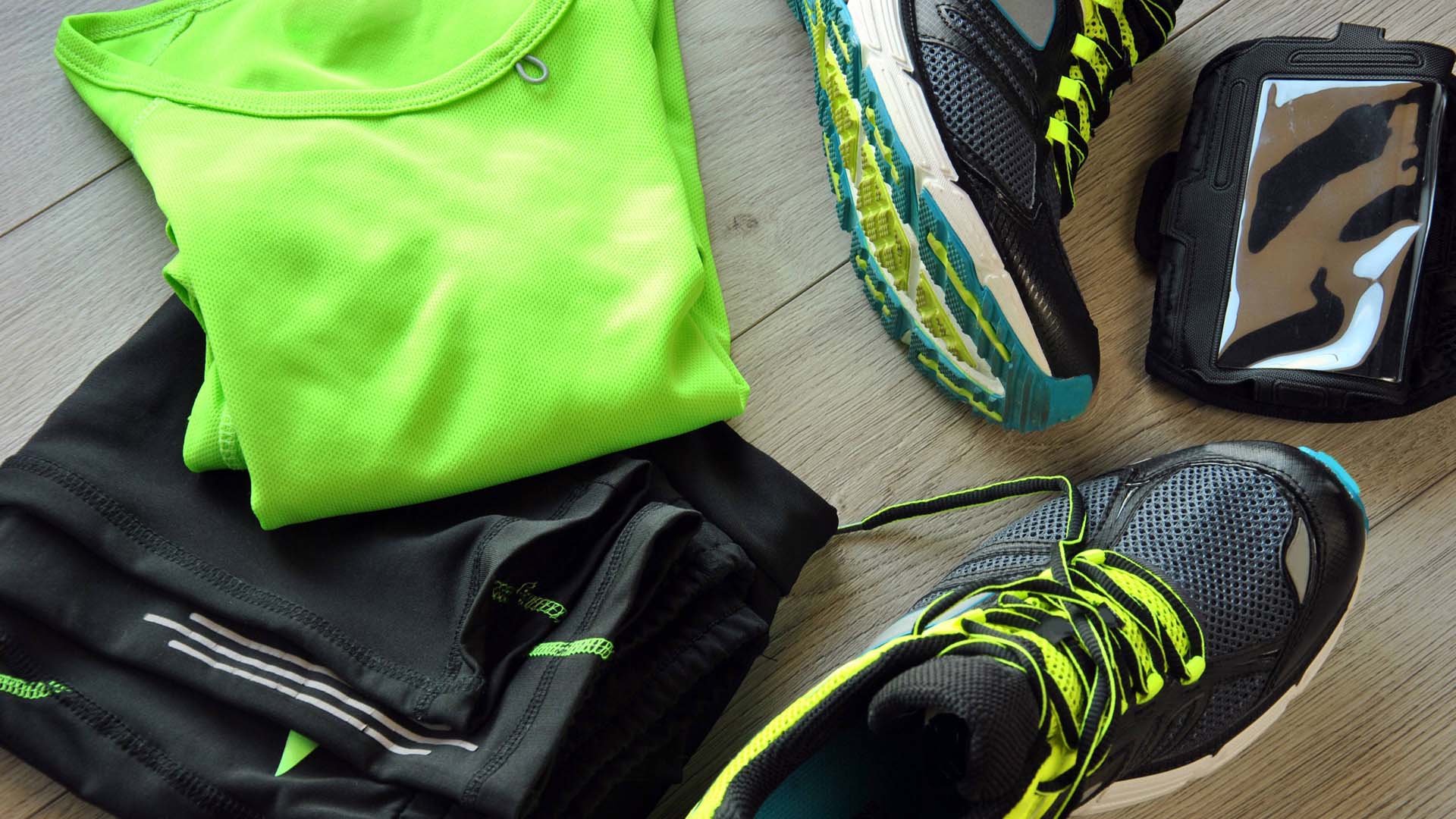 Running gear including a bright yellow top, running trousers, shoes and an armband