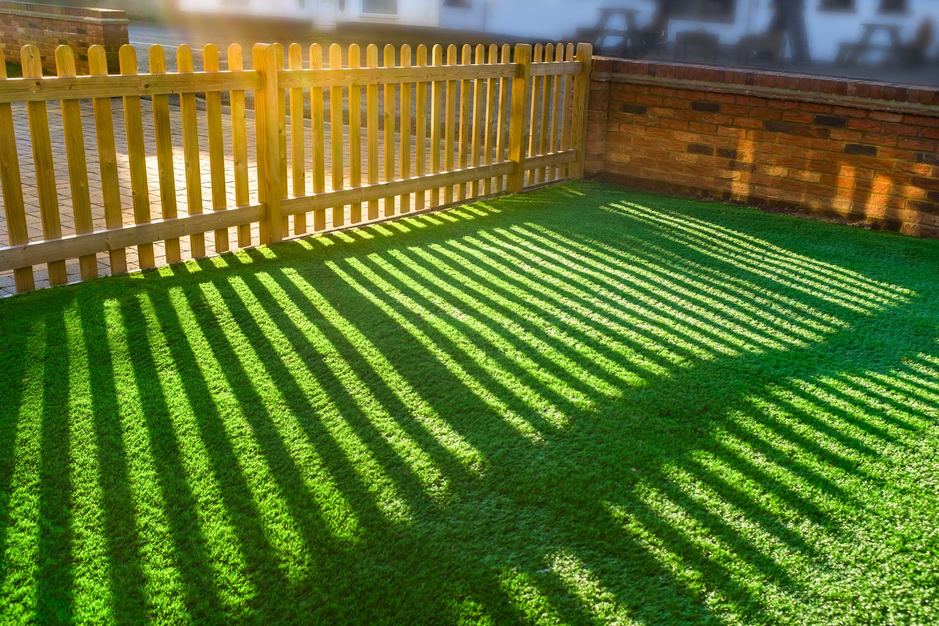 Artificial grass with a picket fence