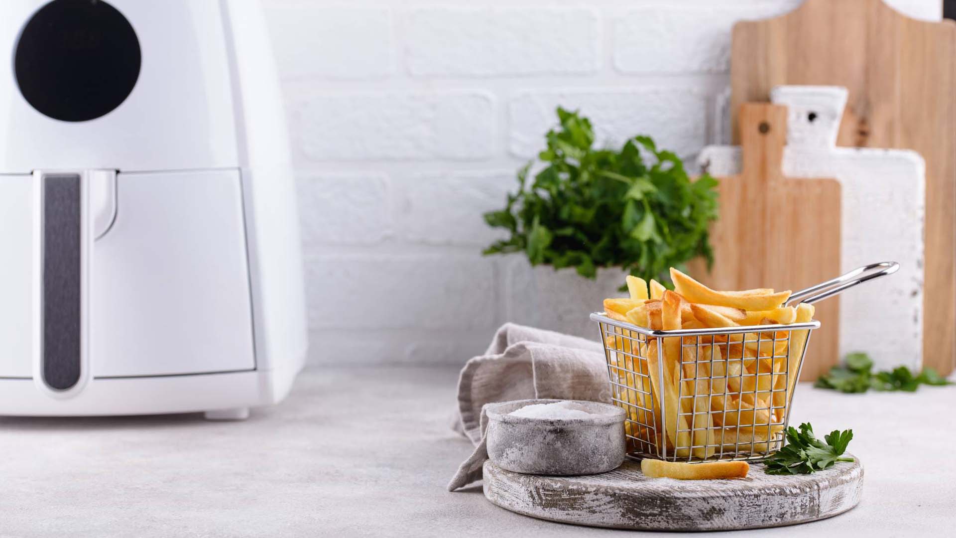 portion of fries next to an air fryer