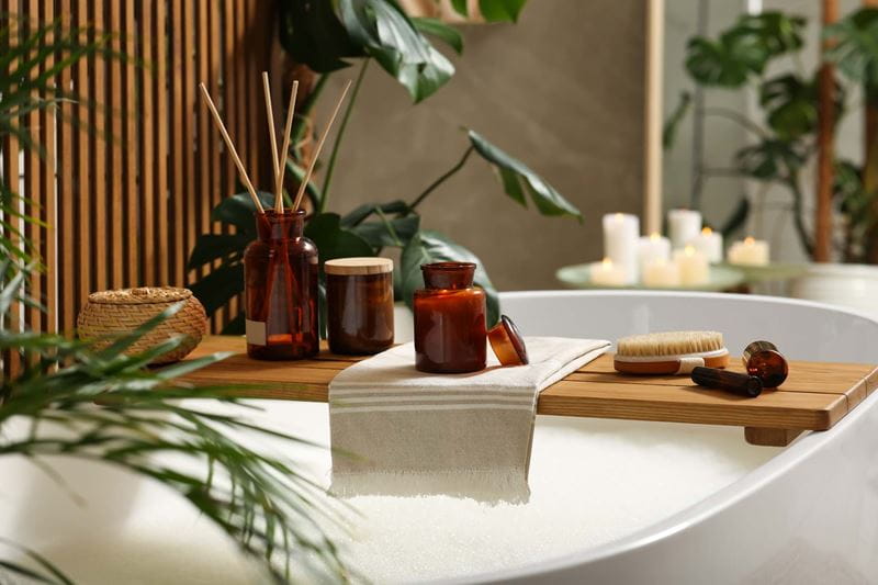 A luxurious bathtub filled with bubbles and other bathtime accoutrements