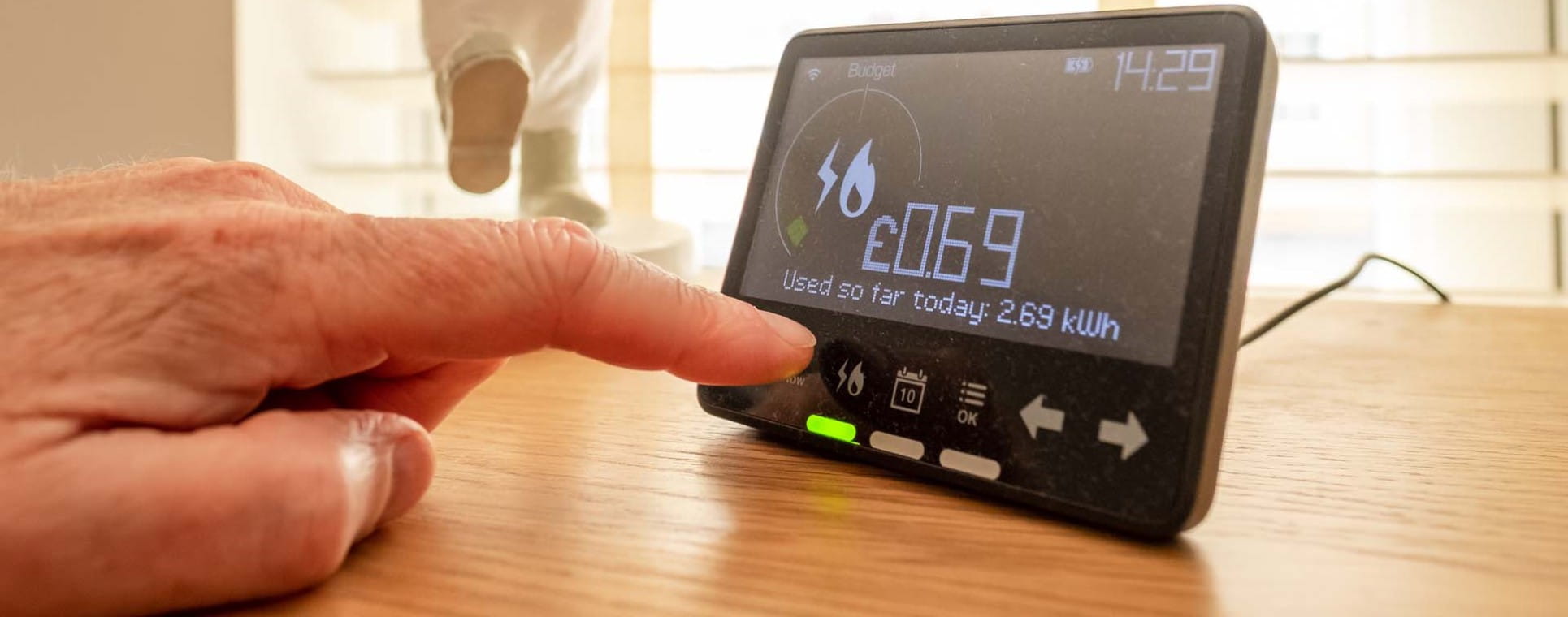 Hand pressing screen of a smart meter