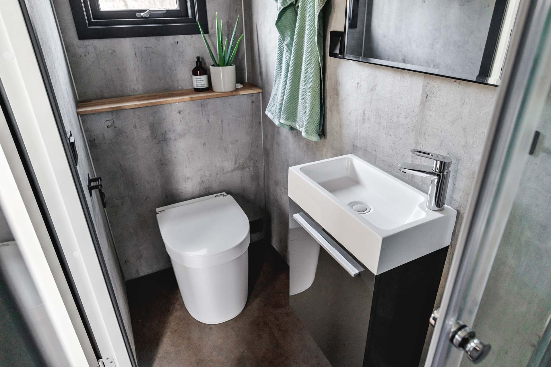 A compost toilet in a small bathroom