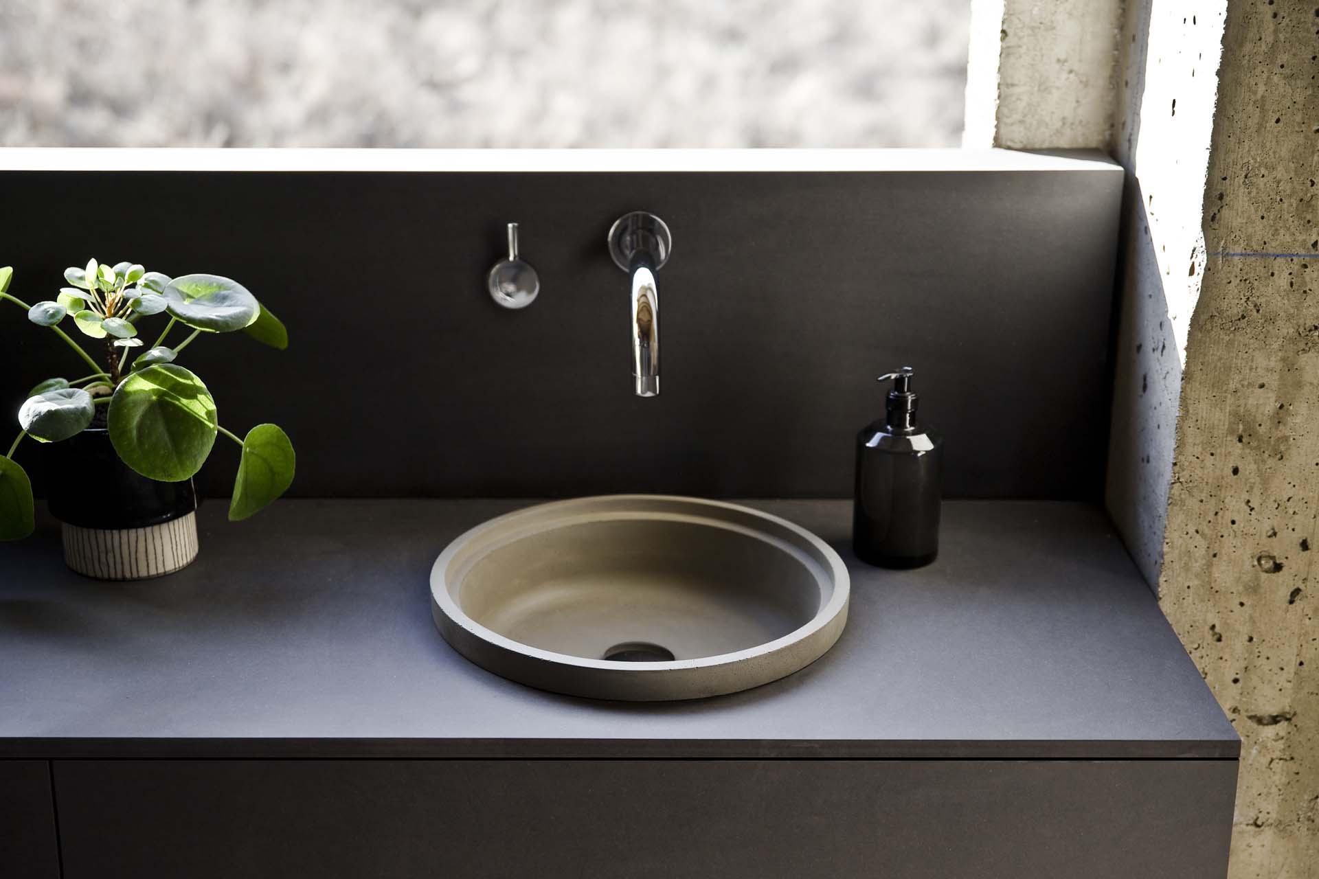 An outdoor round sink with a black surround