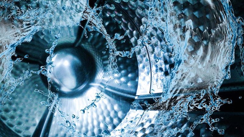 inside of washing machine drum in motion with water
