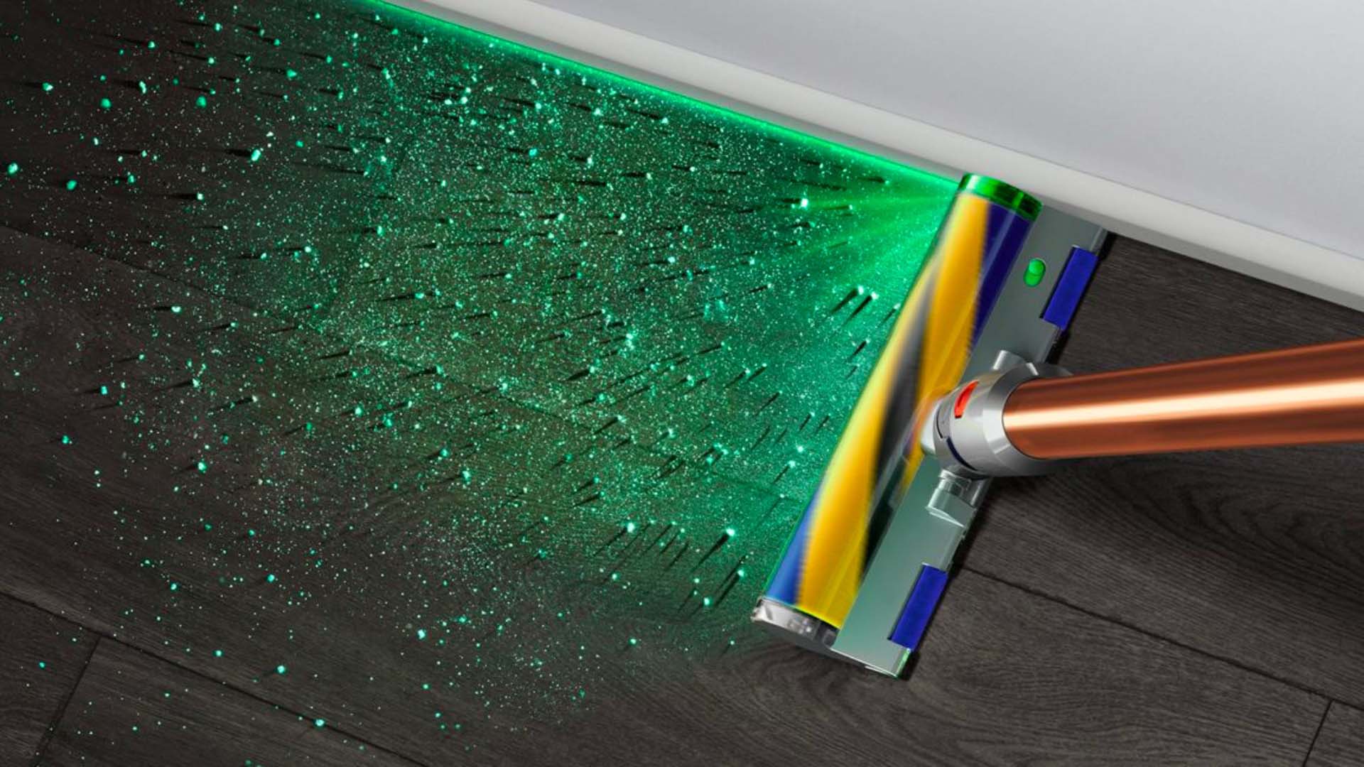A Dyson vacuum with an illuminated cleaner head which projects a green light to show dust particles.