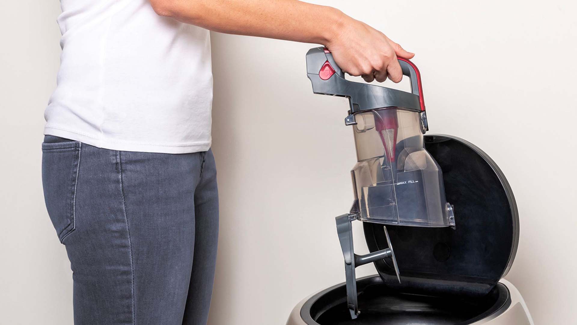 Person emptying their vacuum in a bin