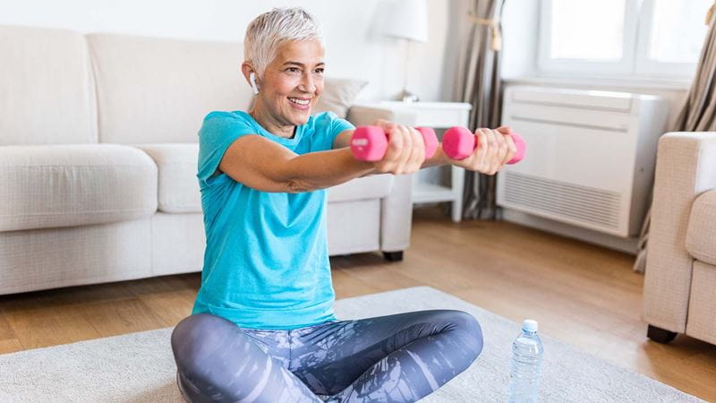 Female lifting weights at home