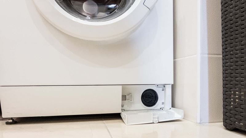 front of washing machine with filter door open at base