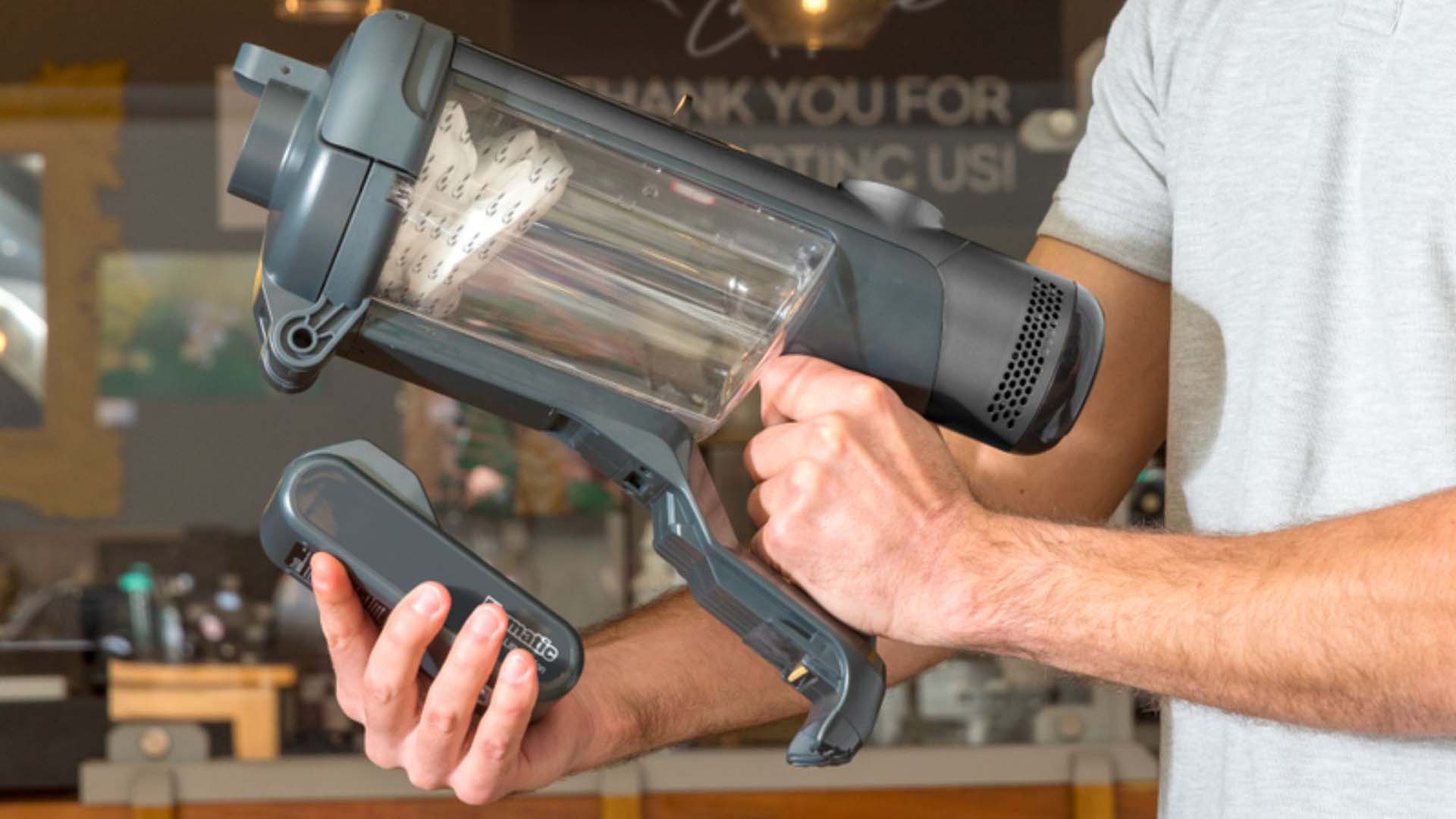 A man replaces the battery of a cordless vacuum