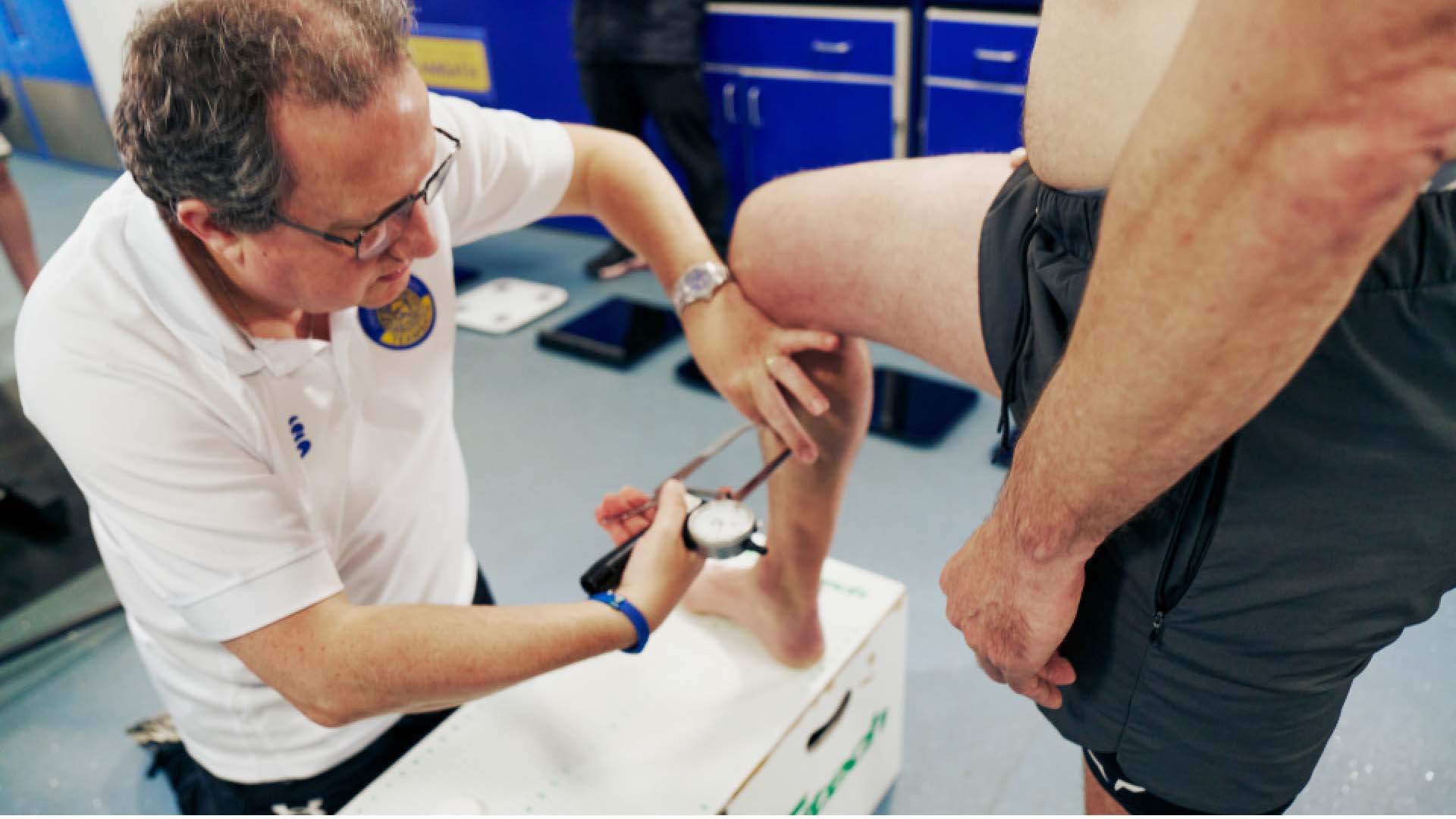 Jonathan Robinson using skin fold callipers on a man's calf muscle