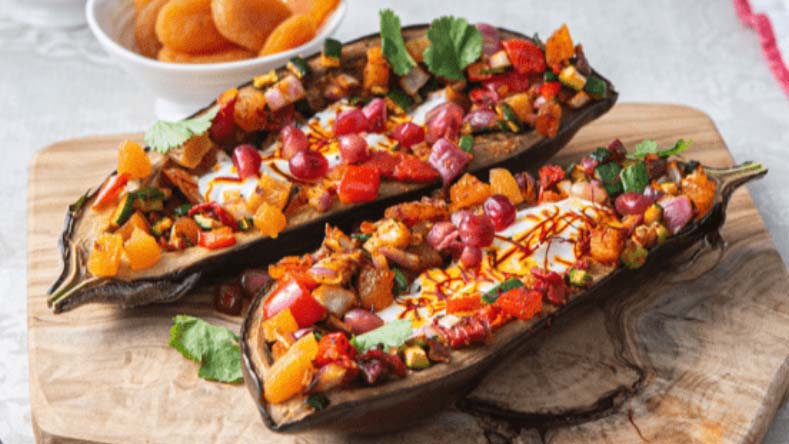 Stuffed aubergines on a choppign board