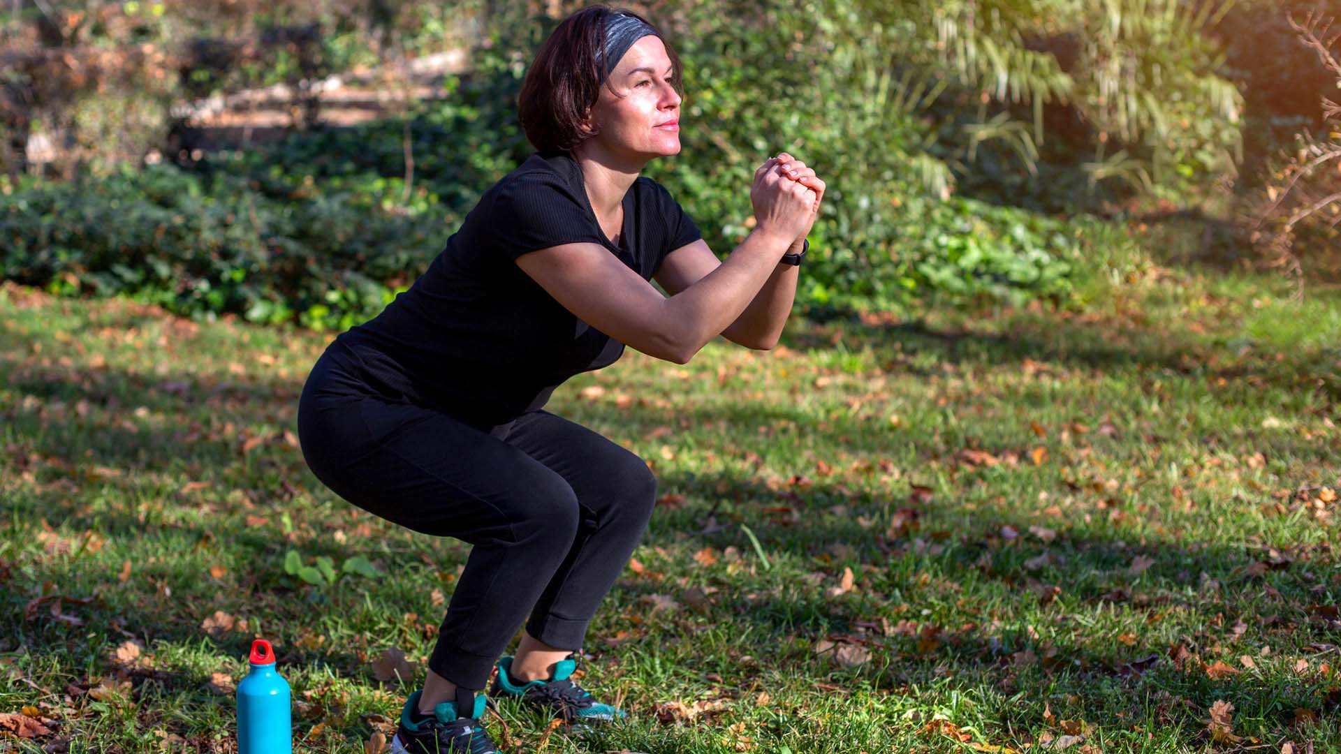 Woman doing squats in the park