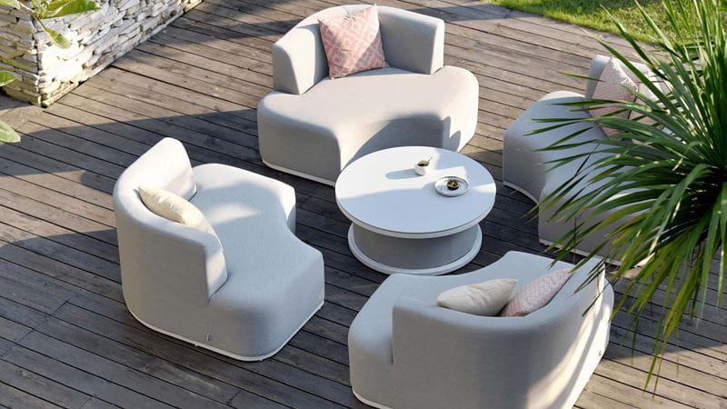 Circular light garden furniture set on top of a wood deck