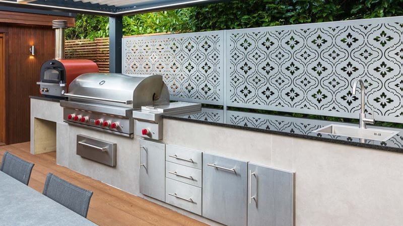 A beautifully tiled outdoor sink area