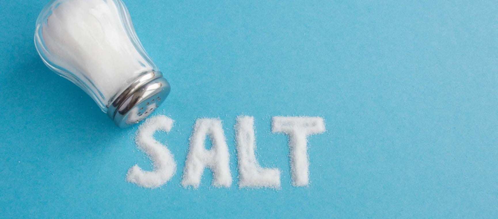 a salt cellar on its side with the word salt written out in salt on a blue background