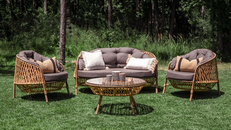 Garden furniture set in the grass, made from Rattan with comfortable cushions