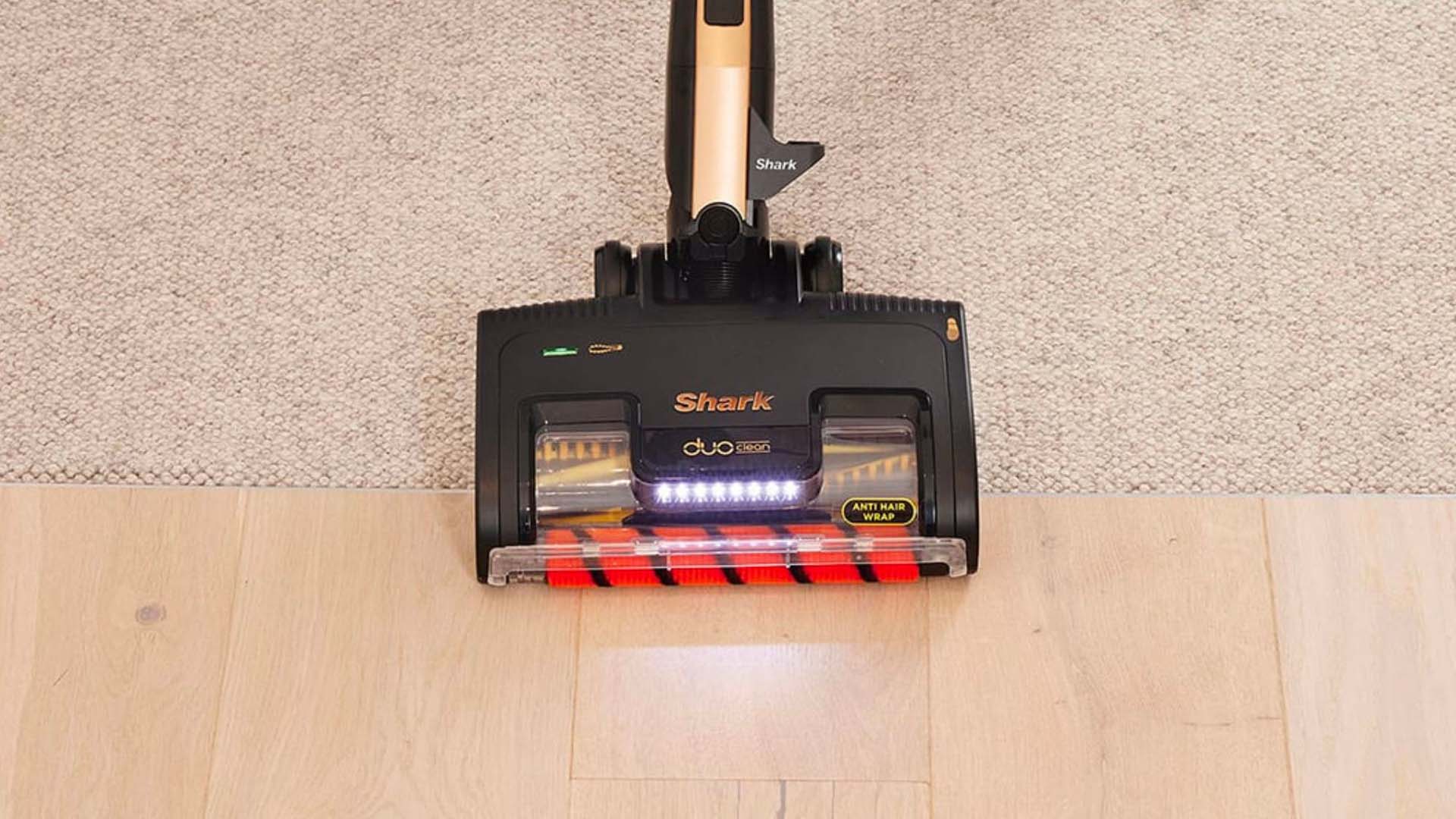 A shark duo clean vacuum on carpet and wood flooring